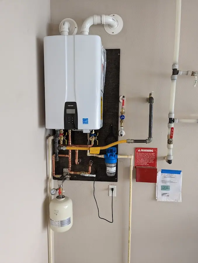 Professional plumber installing copper piping in a Toledo home